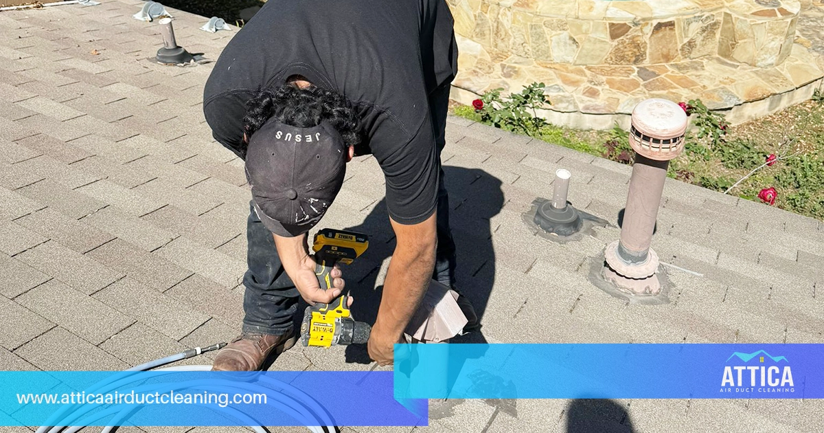 Home dryer vent cleaning, showing a technician from Attica.